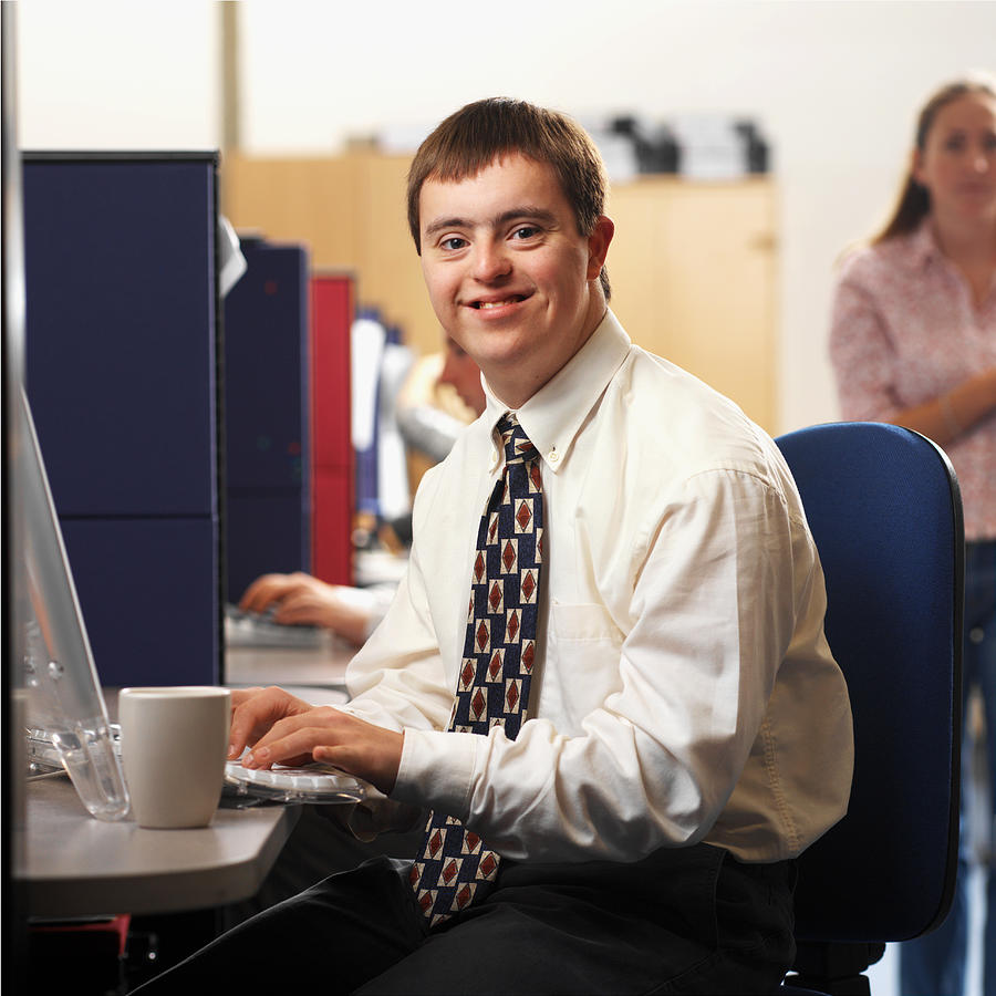 Portrait Of A Man With Down Syndrome Working In An Office #3 Photograph by George Doyle