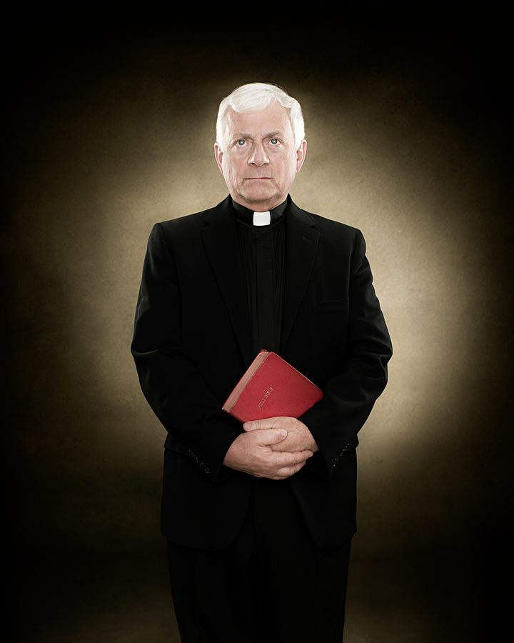 Portrait of a priest holding a bible #3 Photograph by Image Source