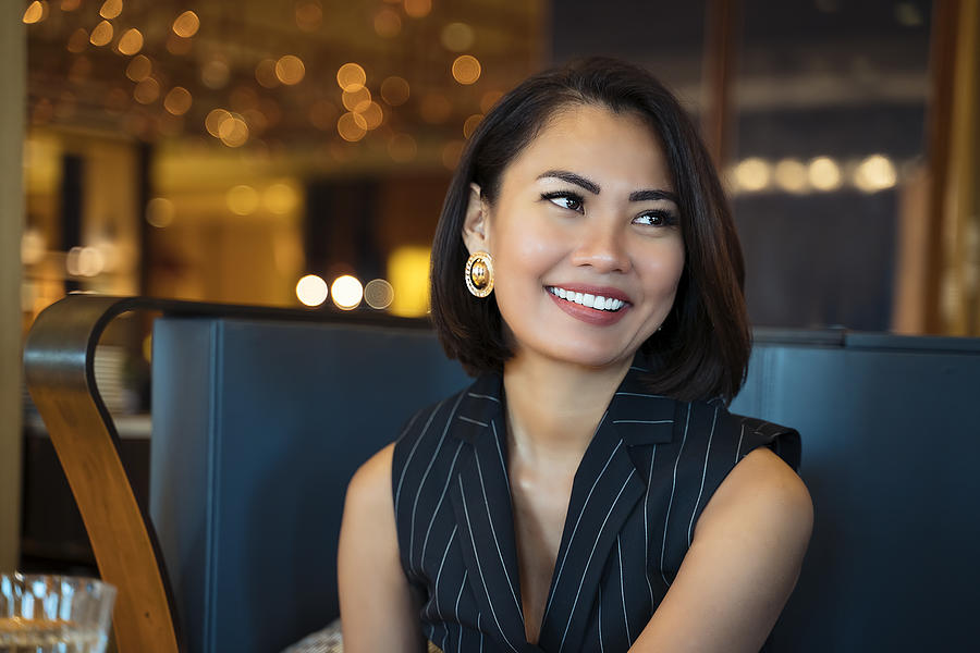 Portrait of an Asian businesswoman smiling at the camera in office #3 Photograph by Enes Evren