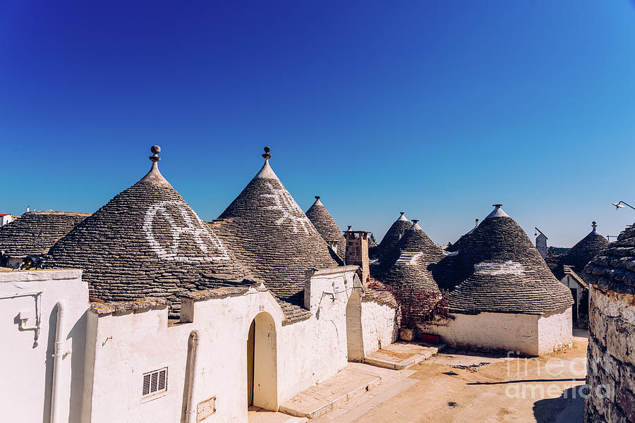  Roofs with symbols in the trulli, in the famous Italian city of Alberobello. #3 Photograph by Joaquin Corbalan
