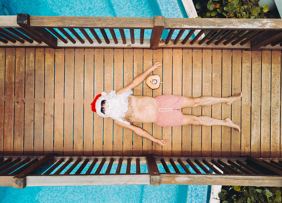 Santa Claus relaxing at the pool #3 Photograph by Orbon Alija
