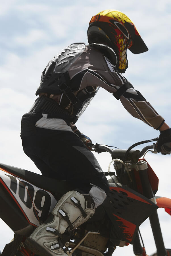 Side profile of a motocross rider riding a motorcycle #3 Photograph by Glowimages