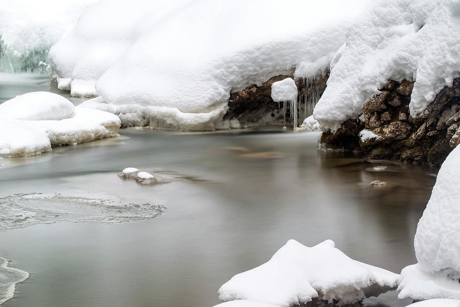 Stunning winter landscape, stones on wintry river covered snow  Photograph by Sebastian Radu