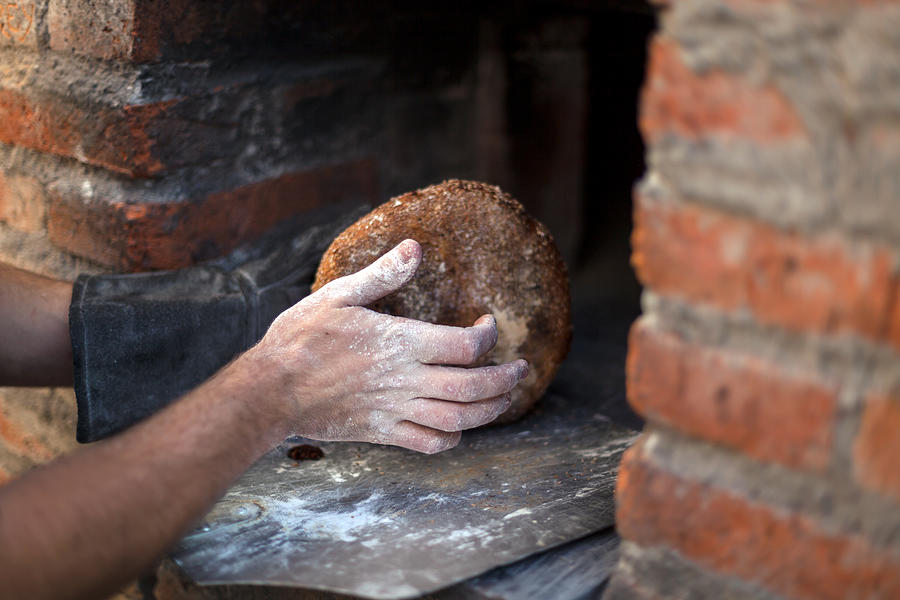 Taking the bread out of the oven #3 Photograph by Jacobo Zanella