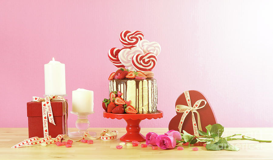 Valentines Day candyland drip cake decorated with heart shaped lollipops. #3 Photograph by Milleflore Images