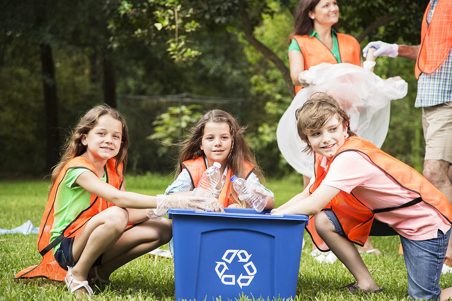 Volunteers: Family cleans up their community park. Recycling bin. #3 Photograph by Fstop123