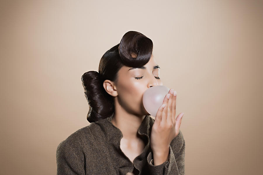 Woman blowing a bubble gum bubble #3 Photograph by Image Source