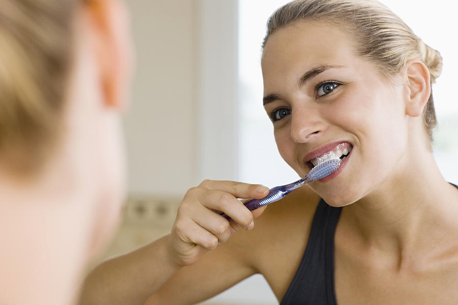 Woman brushing teeth #3 Photograph by Image Source