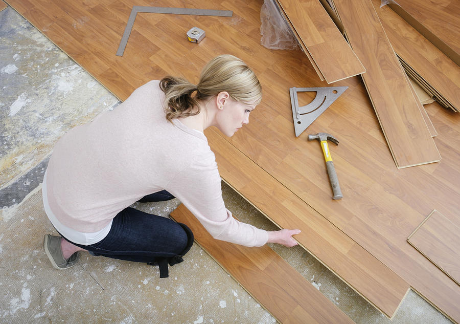Woman Installing Laminate Flooring #3 Photograph by Rich Legg