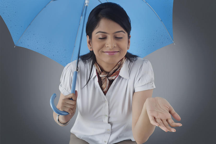 Woman with umbrella enjoying the rain #3 Photograph by Abhinandita Mathur 