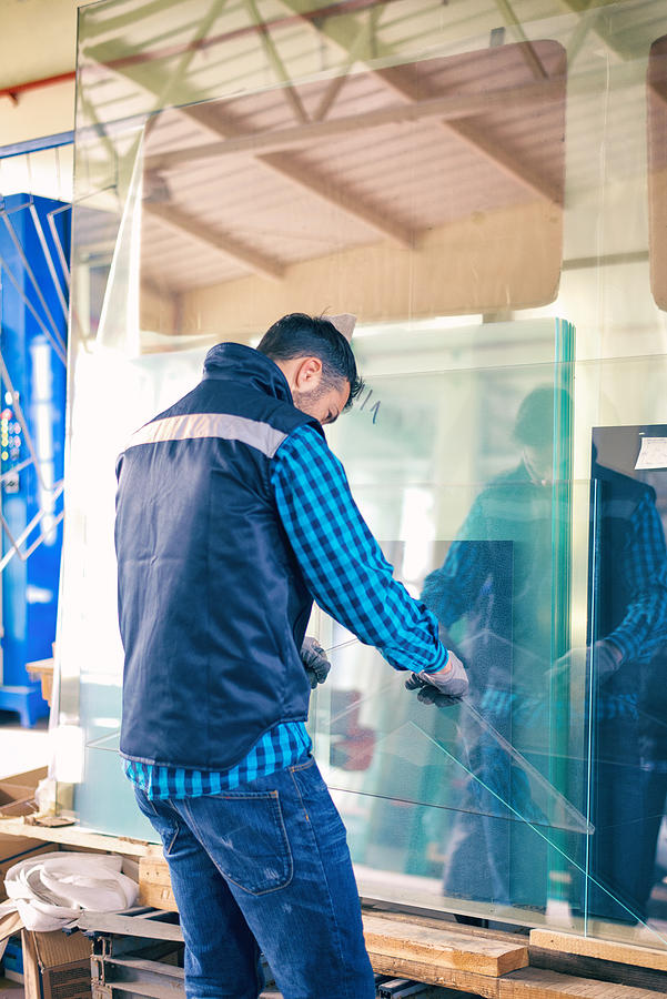 Worker handling glass sheet in warehouse #3 Photograph by Bluecinema