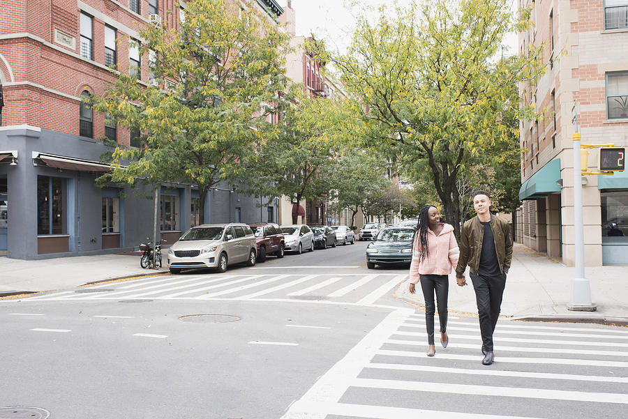 Young couple walking in the city #3 Photograph by Tony Anderson
