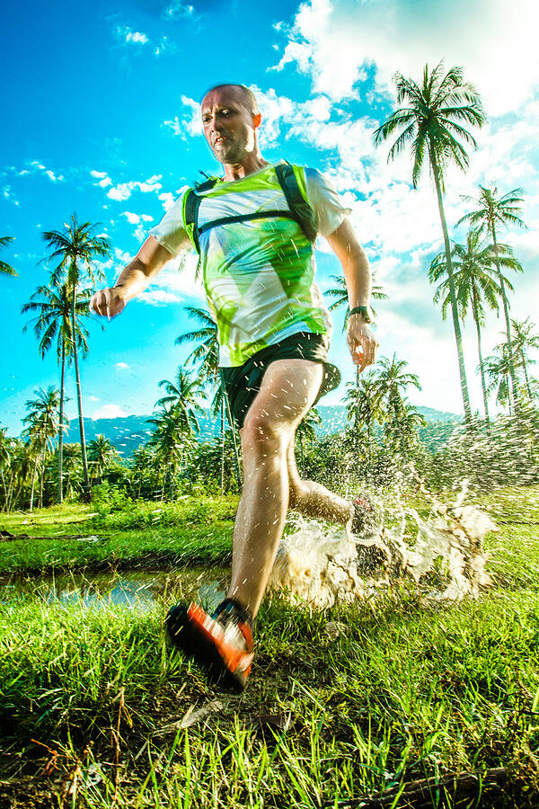 A man jogging in the tropical forrest #4 Photograph by Itsskin