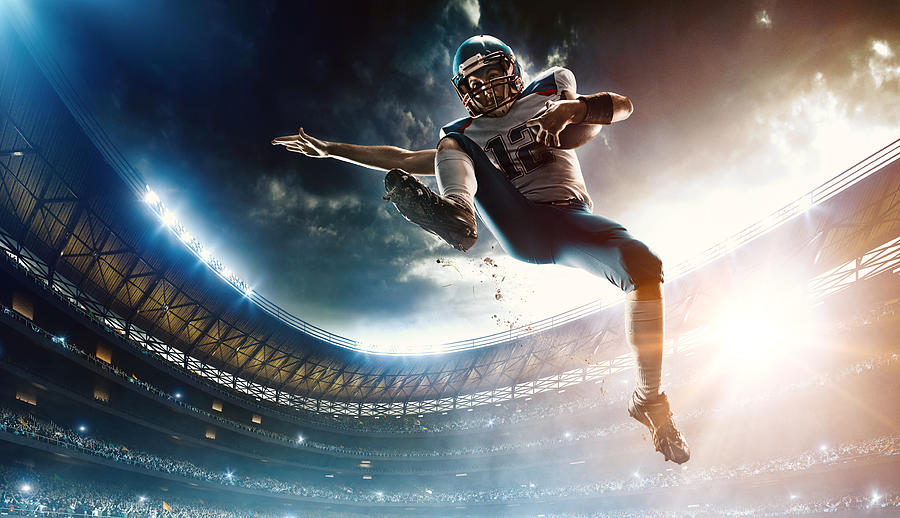 American football player jumping #4 Photograph by Dmytro Aksonov