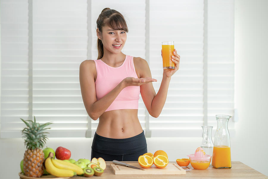 Asian Girl Make An Orange Juice By Hand At Home After Finished E Photograph By Anek Suwannaphoom