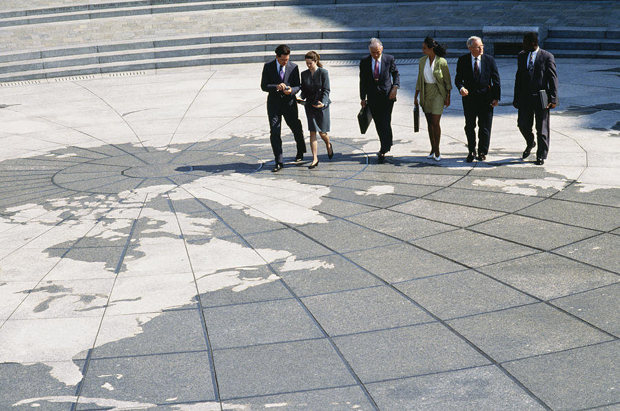 Businesspeople walking on map of globe #4 Photograph by Jon Feingersh Photography Inc