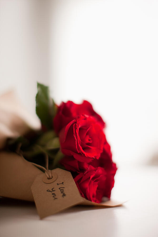Close up of red roses with gift tag #4 Photograph by Tom Merton