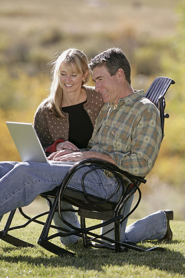 Couple using laptop #4 Photograph by Comstock Images