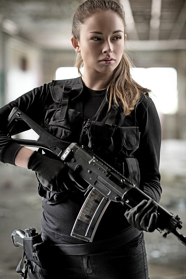 Female military swat team member holding rifle in abandoned warehouse #4 Photograph by Lorado
