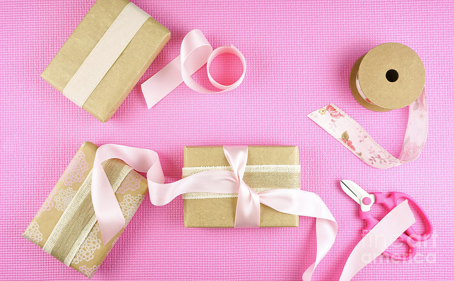 Gifts wrapped in kraft paper and pink ribbons overhead flatlay. #4 Photograph by Milleflore Images