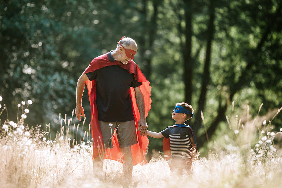 Grandfather Dressed As Superhero Plays Outside With Grandson #4 Photograph by RyanJLane