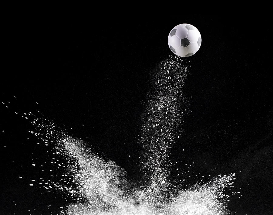 Impact and rebound of a ball of football  on a surface of land and powder on a black background #4 Photograph by Jose A. Bernat Bacete
