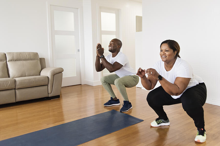 Mature adult couple doing exercise at home. #4 Photograph by Martinedoucet