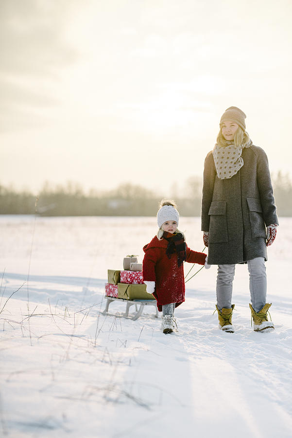 Mother and daughter with christmas presents in the sunset #4 Photograph by Visualspace