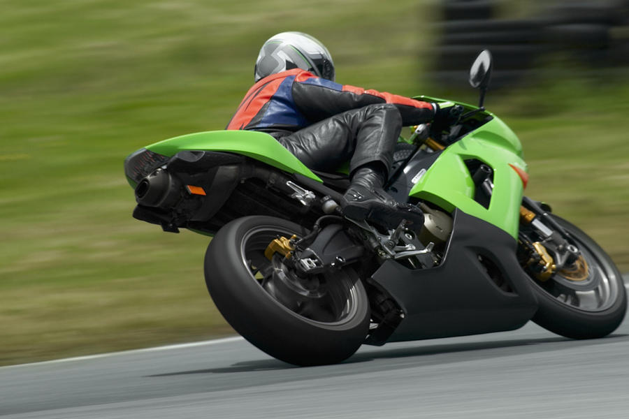 Person riding a motorcycle on a motor racing track #4 Photograph by Glowimages