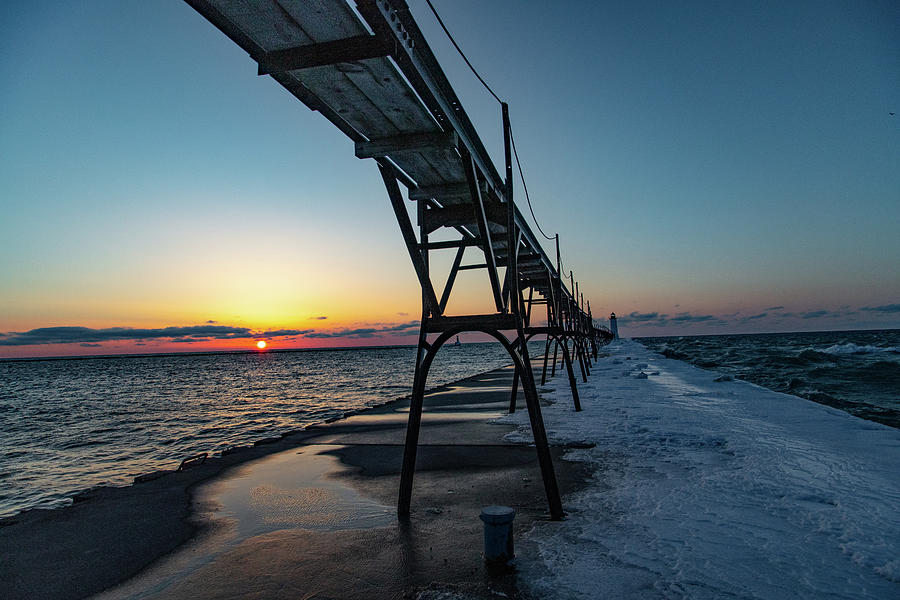 Sunset at Manistee Pier and Lighthouse in Manistee Michigan during the winter #4 Photograph by Eldon McGraw