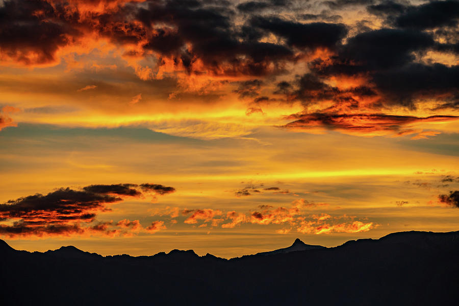 Sunset over the mountains. Dramatic sky at sunset with red, yellow and ...