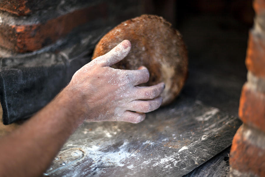 Taking the bread out of the oven #4 Photograph by Jacobo Zanella