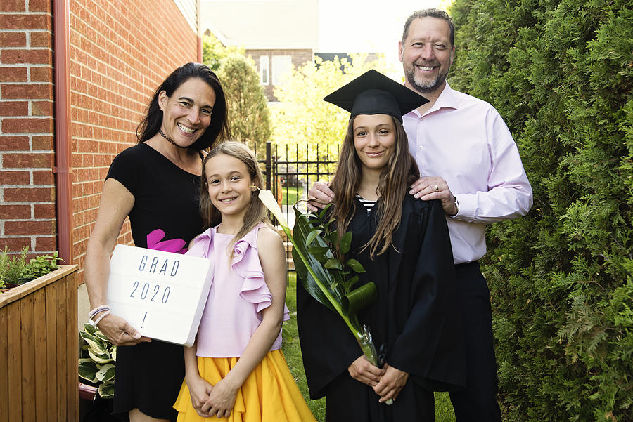 Teenage girl graduation from primary school family portrait in backyard. #4 Photograph by Martinedoucet