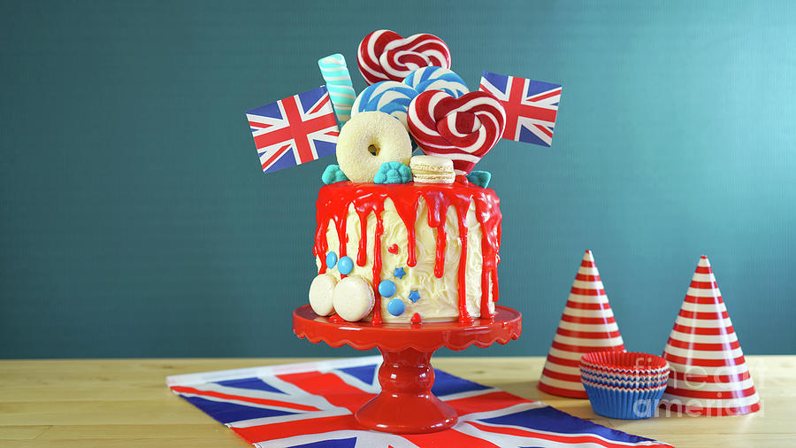 UK candyland drip cake with red white and blue decorations, lollipops and flags. #4 Photograph by Milleflore Images