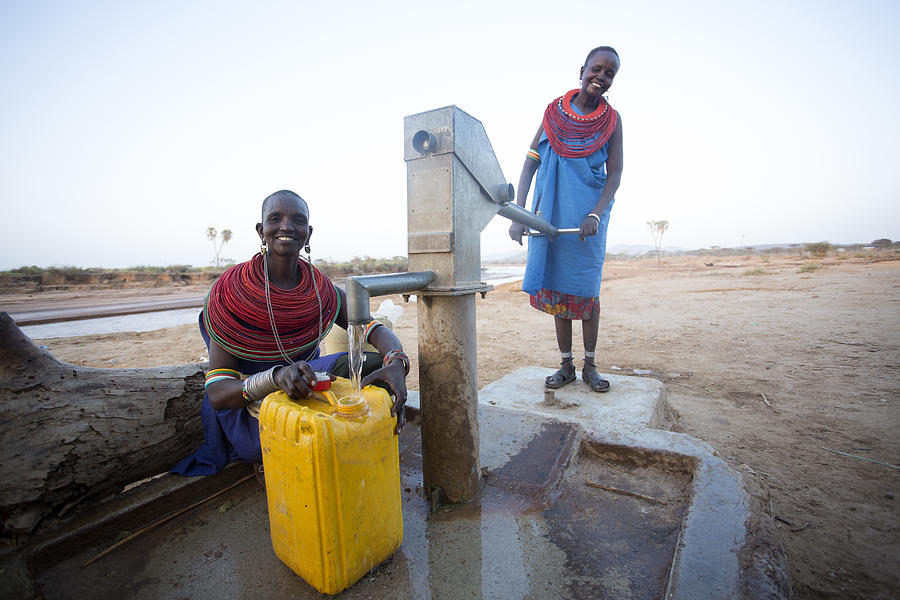 Women collecting clean water from borehole in desert. Samburu. Kenya. #4 Photograph by Hugh Sitton