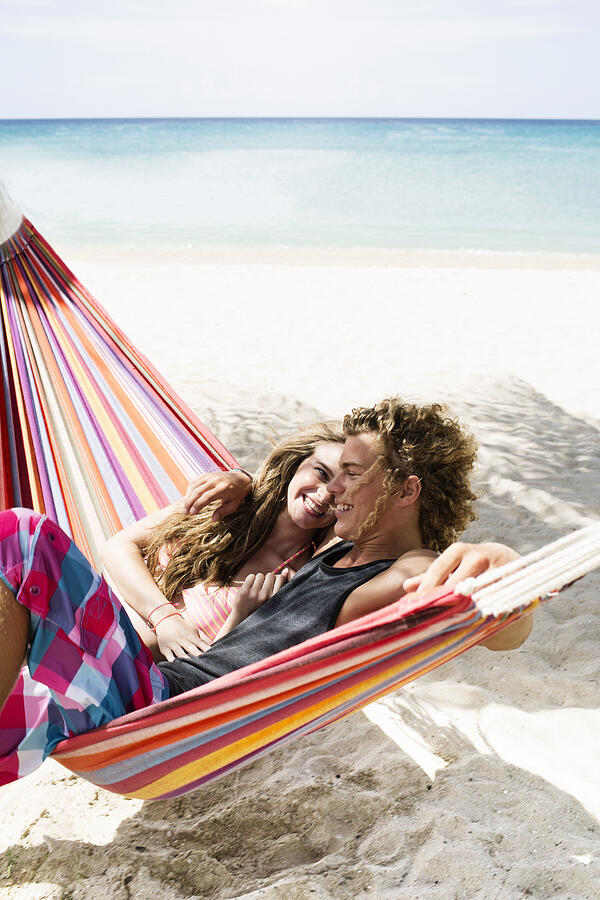 Young couple relaxing in hammock on beach #4 Photograph by Felix Wirth
