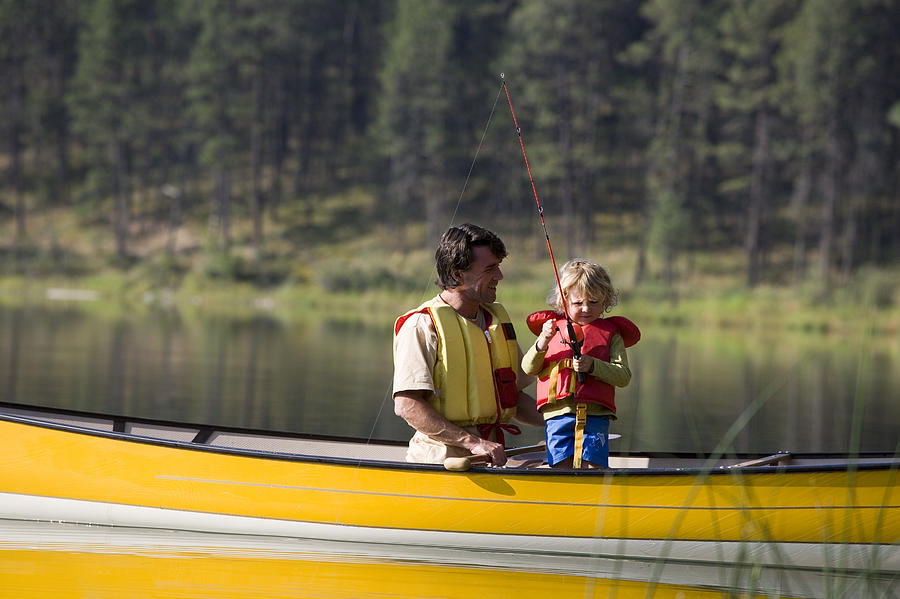 Father and child fishing in a canoe #5 Photograph by Comstock Images