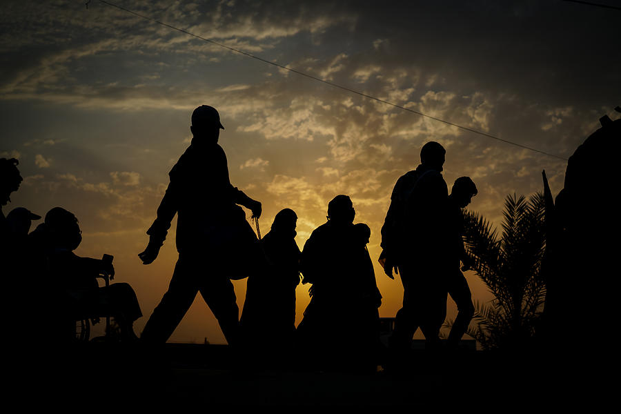 Groups of people walking at sunset #5 Photograph by Jasmin Merdan