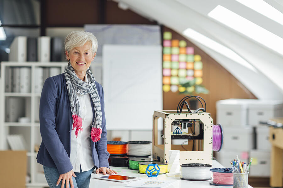 Mature Woman Working By 3D Printer in New Startup Office. #5 Photograph by Vgajic
