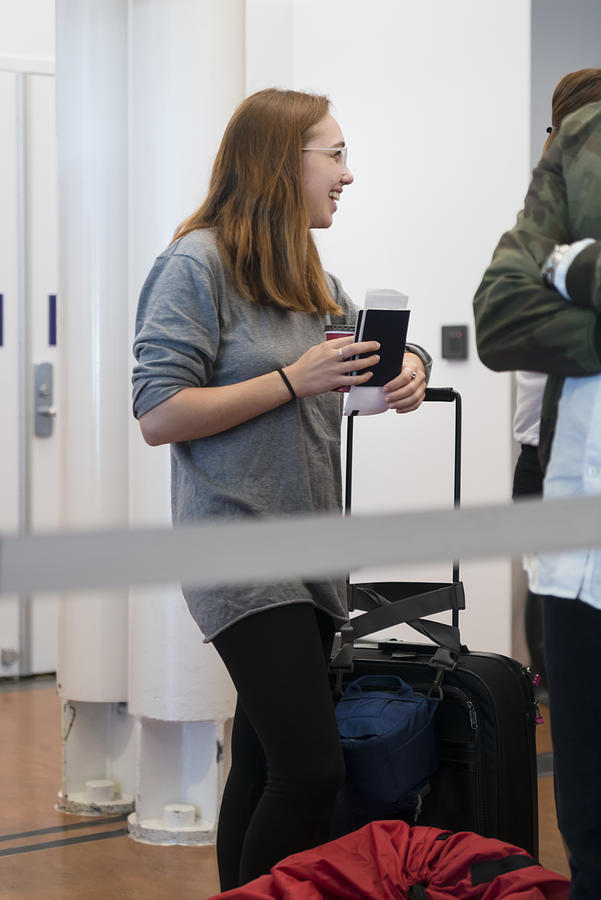 Millennial woman traveling in airport. #5 Photograph by Martinedoucet