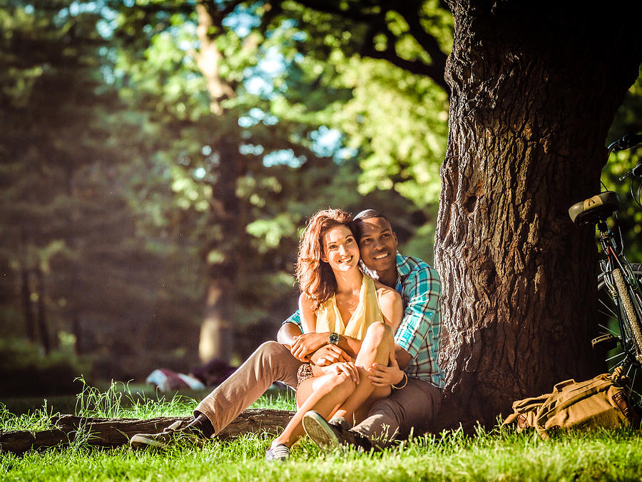 Mixed race couple relaxing in Central Park, New York #5 Photograph by Itsskin