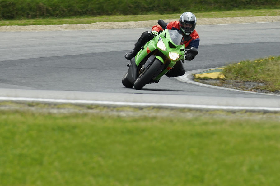 Person riding a motorcycle on a motor racing track #5 Photograph by Glowimages