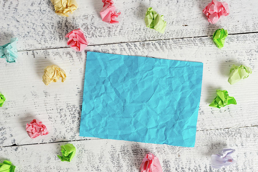 Space Photograph - Rectangle square shaped colored paper in a white wood background. Colorful crumpled note reminder in a blank space. Light wooden table with office idea papers. #5 by Artur Szczybylo