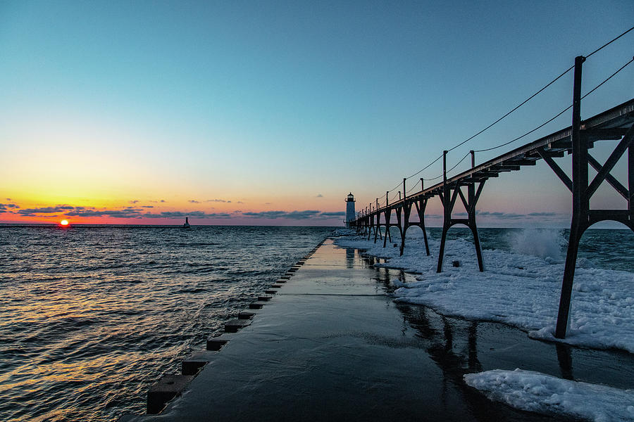 Sunset at Manistee Pier and Lighthouse in Manistee Michigan during the winter #5 Photograph by Eldon McGraw