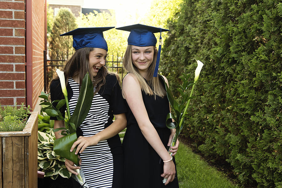 Teenage girls graduation from primary school portrait in backyard. #5 Photograph by Martinedoucet