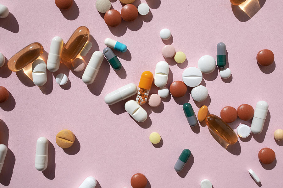 Top view of spoon with various pills and tablets on the pink background #5 Photograph by Yulia Reznikov