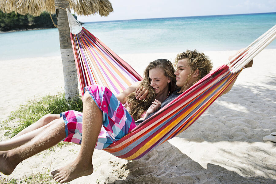Young couple relaxing in hammock on beach #5 Photograph by Felix Wirth