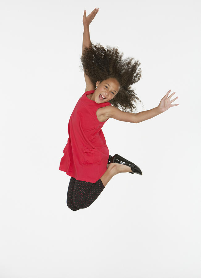 Young girl jumping indoors #5 Photograph by Tom Merton