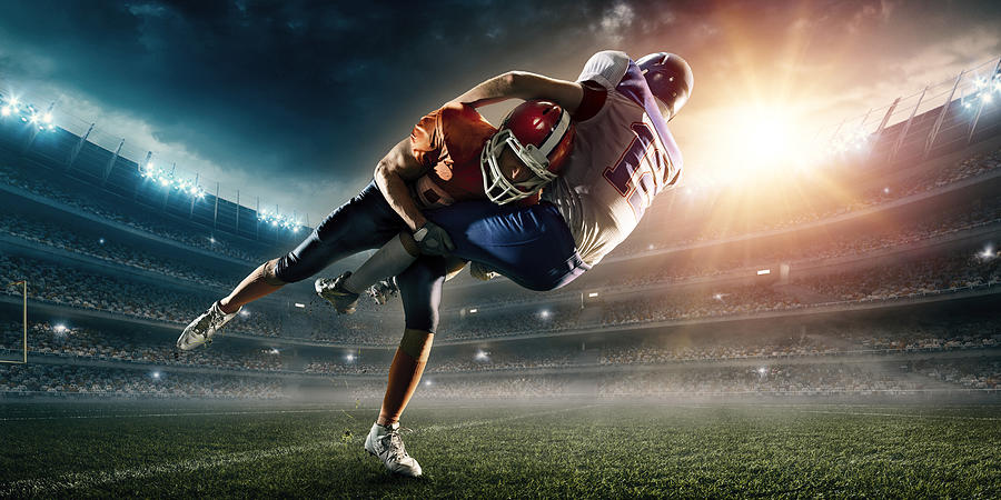 American football player being tackled #6 Photograph by Dmytro Aksonov