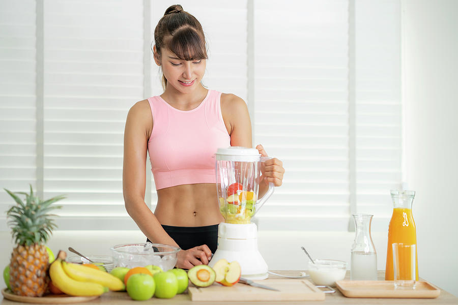 Asian girl prepare material for make a smoothie juice Photograph by ...